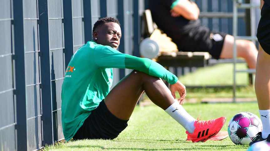 Denis Zakaria von Borussia Mönchengladbach, blickt, geblendet durch die Sonne, in die Kamera eines Fotografen.