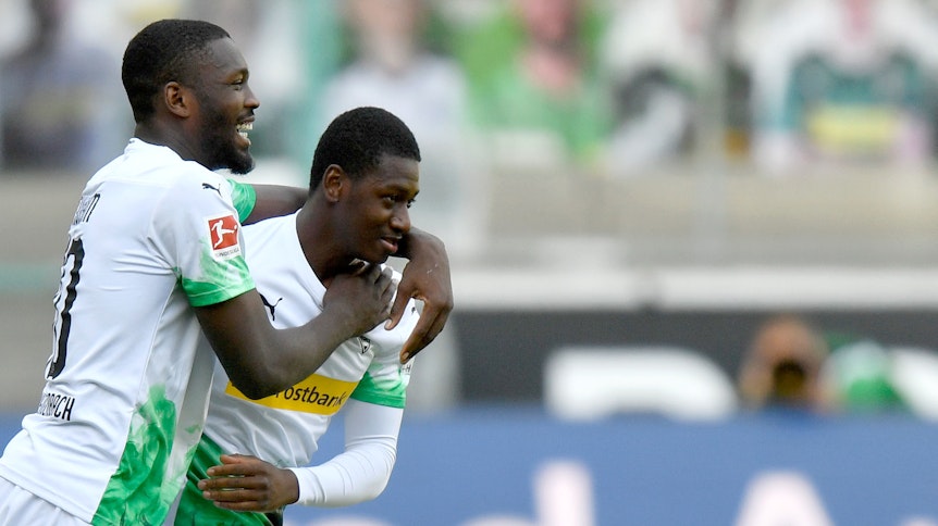 Marcus Thuram feiert Mamadou Doucouré bei dessen Debüt für Borussia Mönchengladbach.