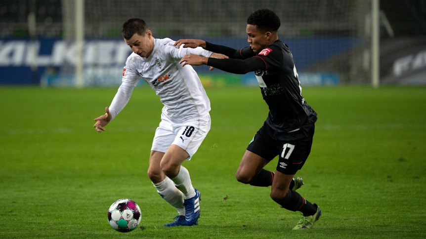 Borussias Rechtsverteidiger Stefan Lainer (l.) wird von Bremens Felix Agu angegangen.