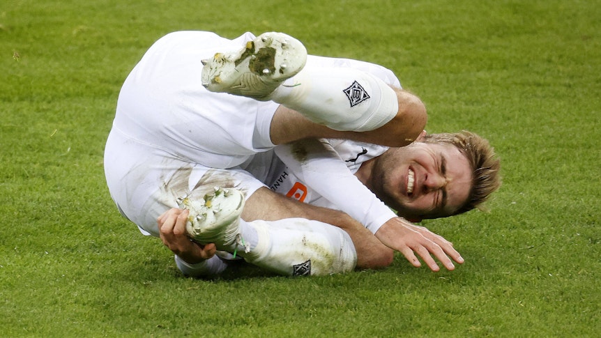 Christoph Kramer, Mittelfeldspieler von Fußball-Bundesligist Borussia Mönchengladbach, hat sich im Training verletzt. Auf diesem Foto ist Kramer am 21. November 2020 im Borussia-Park zu sehen. Er liegt mit schmerzverzerrtem Gesicht auf dem Spielfeld.