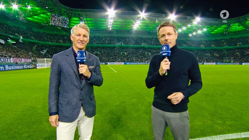 Weltmeister und Ex-Bayern-München-Profi Bastian Schweinsteiger (l.) hat als Experte für die ARD, gemeinsam mit Moderator Alexander Bommes (r.), für die Sportschau das DFB-Pokal-Duell von Borussia Mönchengladbach am 27. Oktober 2021 im Borussia-Park gegen Bayern München analysiert. Beide sprechen vor der Kamera ins Mikrofon.