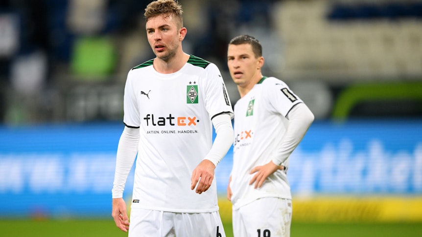 Christoph Kramer (l.) von Borussia Mönchengladbach, hier mit Teamkollege Stefan Lainer (r.), verlässt nach dem 1:1 bei der TSG Hoffenheim am Samstag (18. Dezember 2021) mit angefressenem Gesichtsausdruck das Spielfeld.