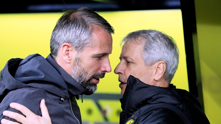 Das Fanprojekt von Borussia Mönchengladbach hat noch einmal mit Ex-Trainer Marco Rose (l.) abgerechnet und segnet die nahende Entscheidung, dass Lucien Favre (r.) neuer Fohlen-Coach werden soll, ab. Auf diesem Foto sind Favre und Rose am 19. Oktober 2019 in Dortmund zu sehen. Favre und Rose umarmen sich.