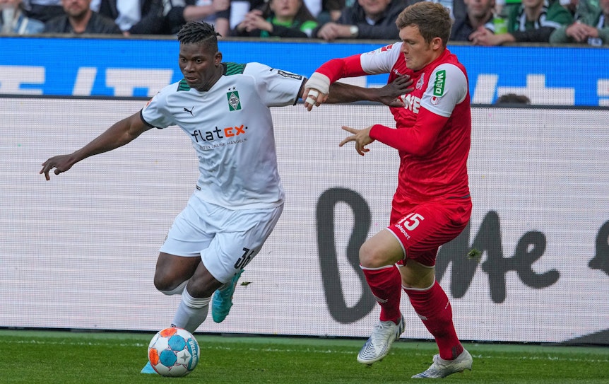 Breel Embolo (l.) von Borussia Mönchengladbach im Duell mit Luca Kilian vom 1. FC Köln am 16. April 2022 im Borussia-Park. Embolo hat den Ball vor sich.