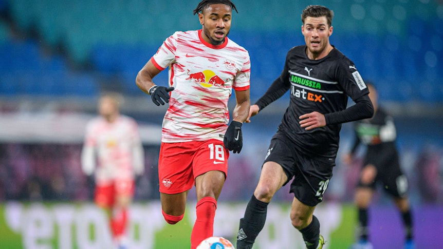 Borussia Mönchengladbach empfängt am Montag (2. Mai 2022) RB Leipzig zum Duell des 32. Bundesliga-Spieltags. Das Foto zeigt Leipzigs Christopher Nkunku (l.) im Duell mit Gladbachs Joe Scally (r.) im Hinspiel am 11. Dezember 2021.
