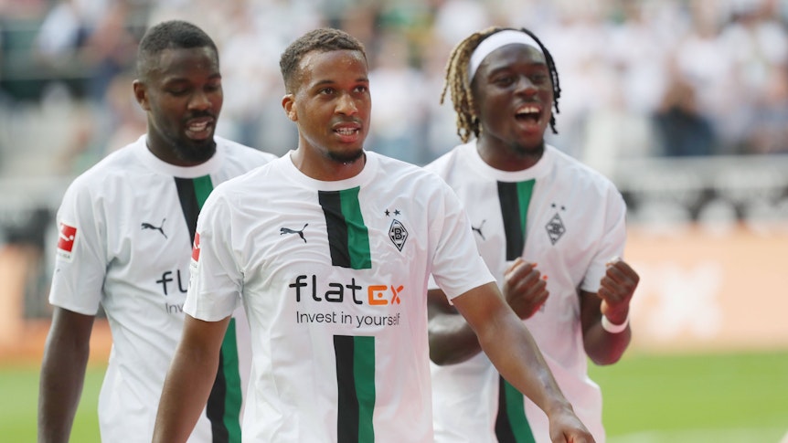 Alassane Plea (Mitte) ist „Borussia-Spieler des Spiels“. Auf diesem Foto ist der Franzose nach dem Bundesliga-Sieg (6. August 2022) gegen die TSG Hoffenheim zu sehen. Seine Teamkollegen Marcus Thuram (l.) und Manu Kóne (r.) sind auch dabei. Die Gladbach-Profis freuen auch über den Erfolg.