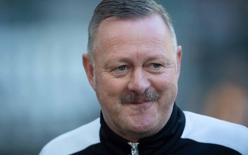 Roland Virkus ist Sportdirektor bei Fußball-Bundesligist Borussia Mönchengladbach, auf diesem Bild ist der 56-Jährige am 17. September 2022 im Borussia-Park zu sehen. Virkus lächelt, er trägt eine schwarz-weiße Trainingsjacke.