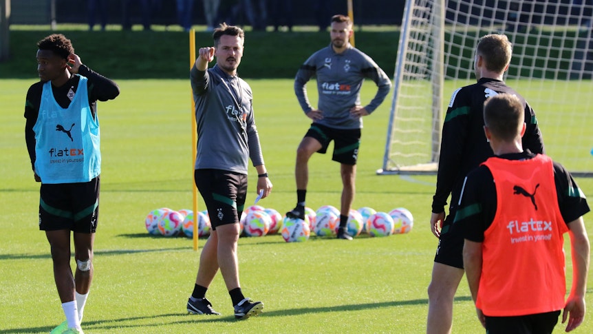 Edmund Riemer, Co-Trainer von Borussia Mönchengladbach (2. v. l.) und derzeitiger Stellvertreter des an Corona erkrankten Cheftrainers Daniel Farke am Mittwoch (5. Oktober 2022) auf dem Trainingsplatz im Borussia-Park. Riemer gibt mit dem rechten Arm Anweisungen. Nathan Ngoumou, Co-Trainer Christopher John, Marvin Friedrich und Patrick Herrmann sind ebenfalls zu sehen.