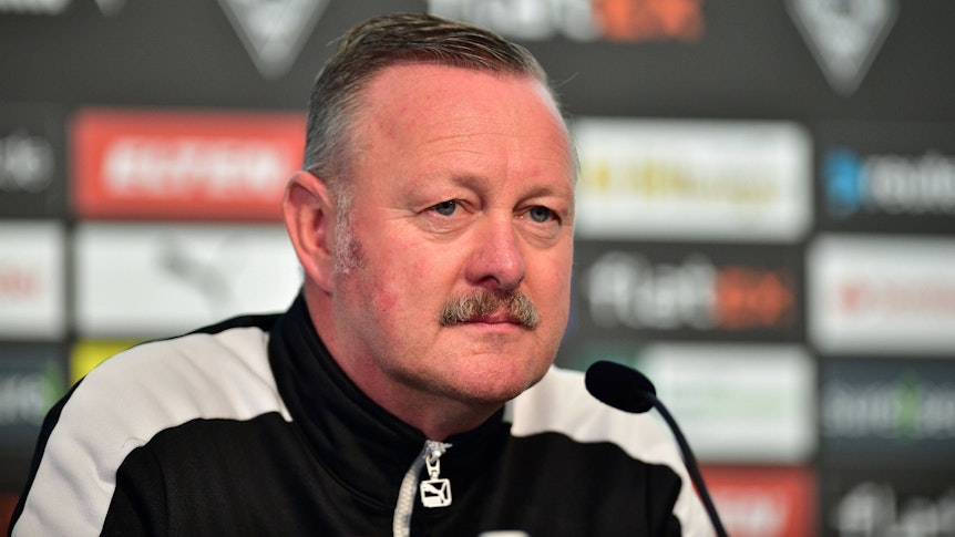 Roland Virkus, Sportdirektor von Fußball-Bundesligist Borussia Mönchengladbach. Hier ist der 55-Jährige am 7. Oktober 2022 bei der Derby-Pressekonferenz im Borussia-Park zu sehen. Virkus schaut nach vorne, er trägt eine schwarz-weiße Trainingsjacke.