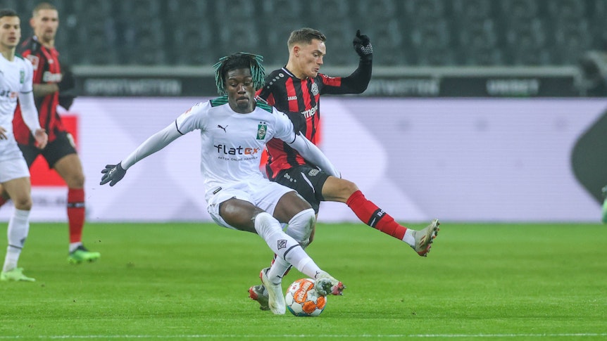 Am Sonntag (22. Januar 2023/17.30 Uhr) trifft Borussia Mönchengladbach in der Bundesliga auf Bayer 04 Leverkusen. Das Foto zeigt Manu Koné (l.) im Duell um den Ball mit Florian Wirtz (r.).