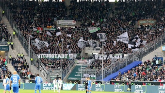 Der Fan-Block von Borussia Mönchengladbach während des Bundesliga-Spiels (28. Januar 2023) bei der TSG Hoffenheim in der Sinsheimer Arena. Zu sehen sind Banner der Gladbach-Ultras und Fahnen.