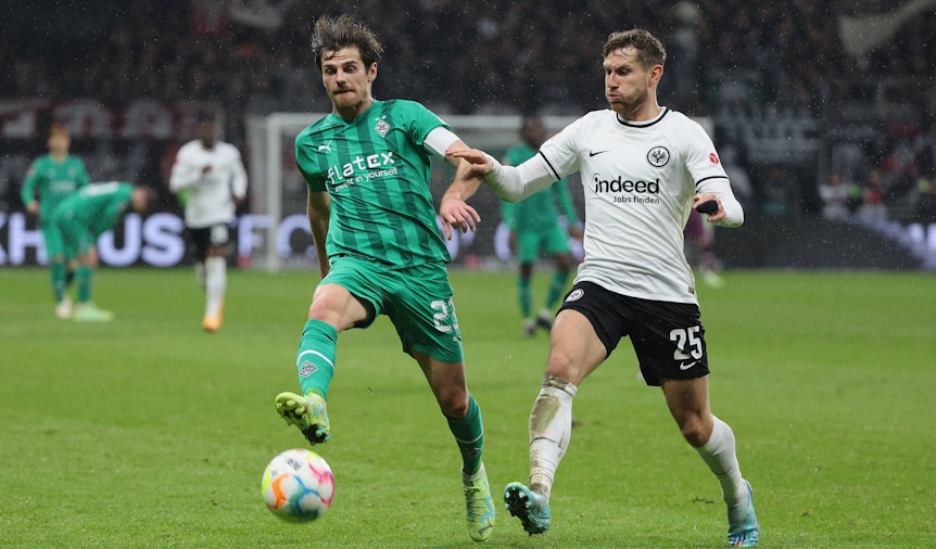 Jonas Hofmann von Borussia Mönchengladbach (l.) am 15. April 2023 im Zweikampf mit Christopher Lenz von Eintracht Frankfurt.