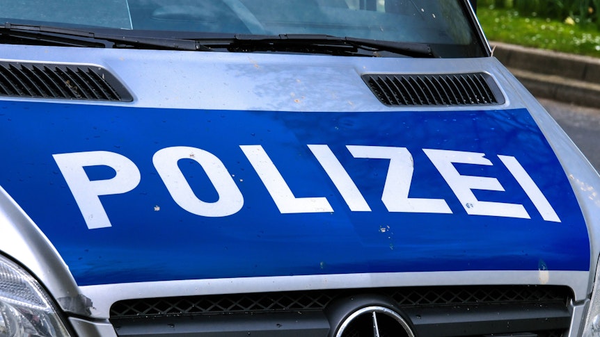 Dieses Symbolfoto zeigt einen Polizeiwagen im Einsatz. Das Bild ist am 23. April 2023 aufgenommen worden. Zu sehen ist die Motorhaube des Fahrzeugs mit der Aufschrift Polizei.