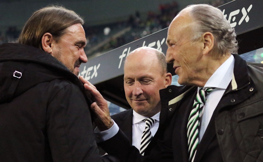 Gladbach-Präsident Rolf Königs (r.) im Gespräch mit Borussia-Trainer Daniel Farke (l.), zu sehen ist auch Finanzchef Stephan Schippers (M). Das Foto ist am 11. November 2022 im Borussia-Park entstanden. Königs lächelt und greift Farke an die Schulter.