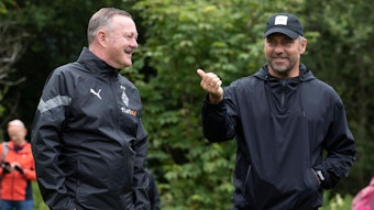 Roland Virkus (l.), Manager von Borussia Mönchengladbach, unterhält sich am 7. Juli 2022 mit Bundestrainer Hansi Flick.