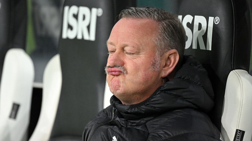 Roland Virkus sitzt entspannt auf der Borussia-Bank.