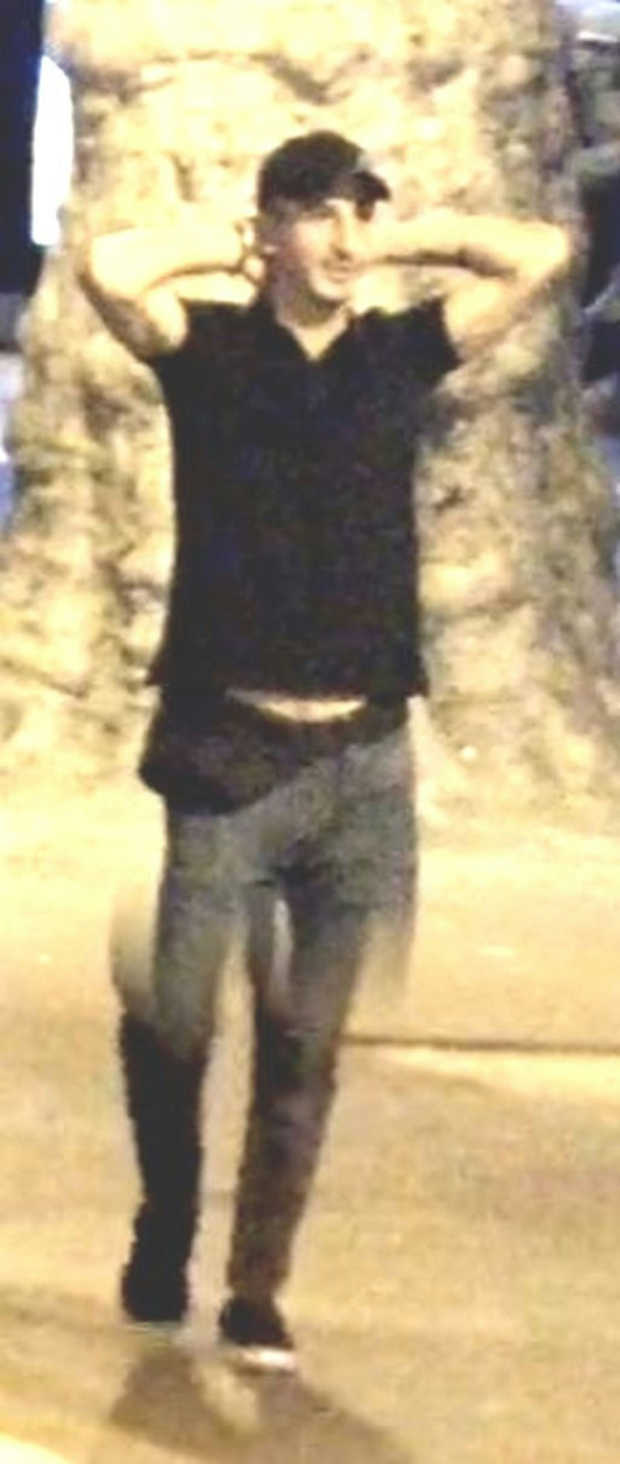 Ein junger Mann trägt ein Basecap und hält beide Hände hinter den Kopf.