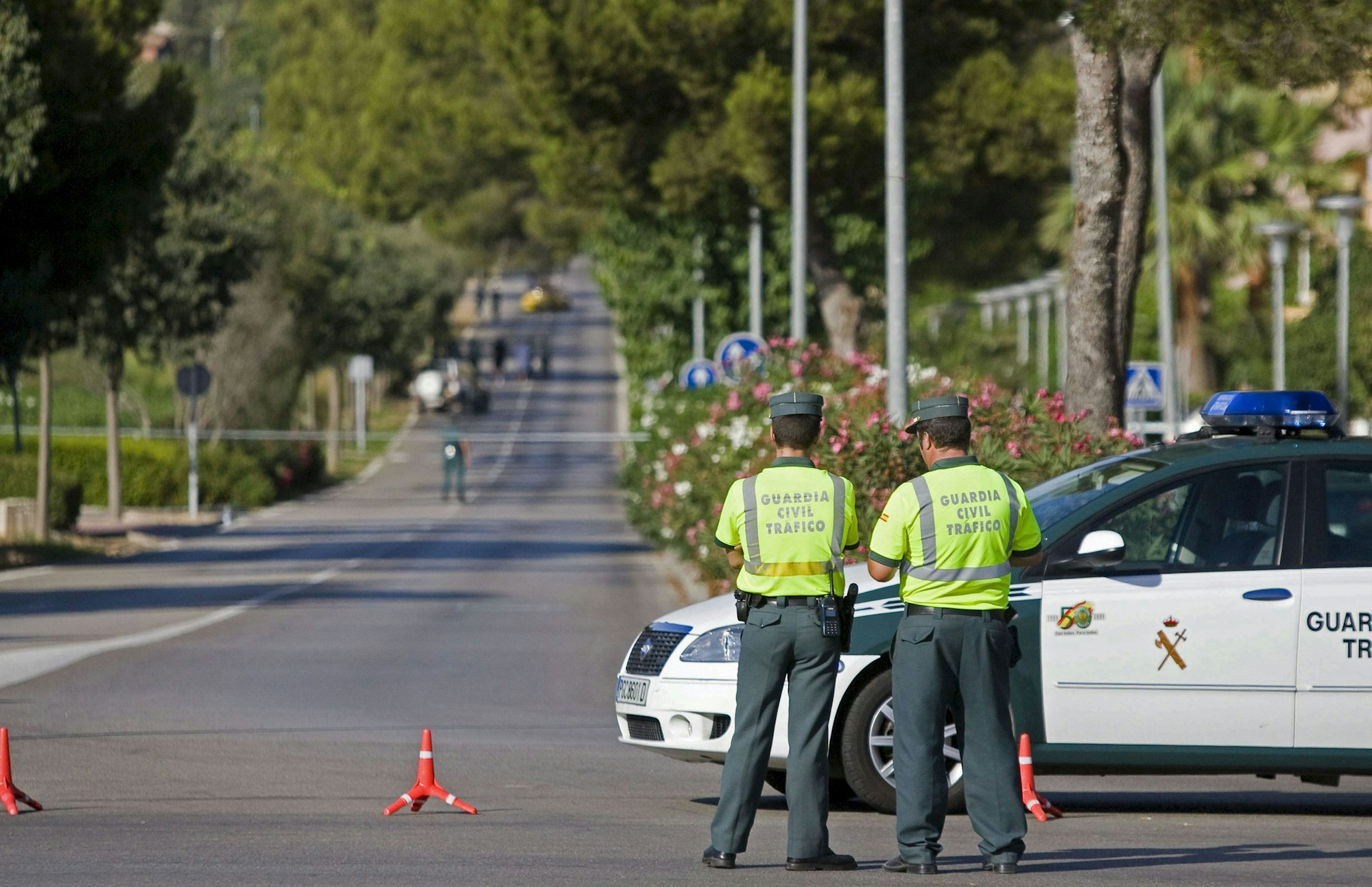 Beamte der spanischen Guardia Civil stehen auf einer Straße.