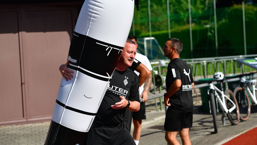 Roland Virkus posiert neben einem Trainingsgegenstand.