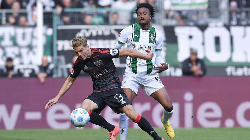 Borussia Mönchengladbachs Nathan Ngoumou und Union Berlins Andras Schäfer kämpfen um den Ball.