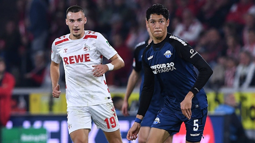 Paderborns Santiago Castaneda führt den Ball im Spiel beim 1. FC Köln. FC-Profi Tim Lemperle verfolgt ihn.