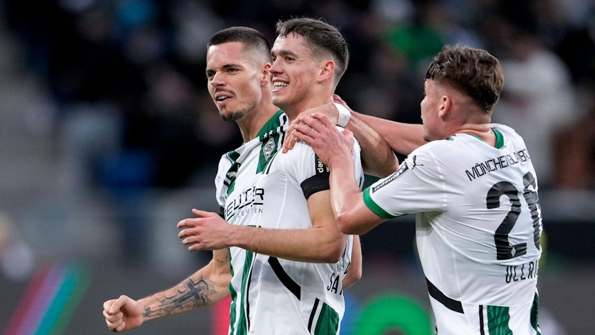 Drei Profis von Borussia Mönchengladbach bejubeln einen Treffer.