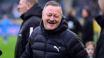 Roland Virkus lächelt vor einem Spiel.