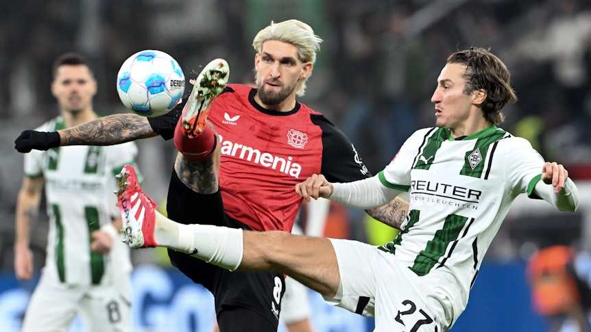 Bayer Leverkusens Robert Andrich und Borussia Mönchengladbachs Rocco Reitz kämpfen um den Ball.