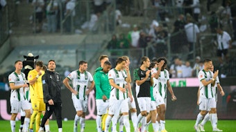 Spieler von Borussia Mönchengladbach schlendern frustriert vom Platz.