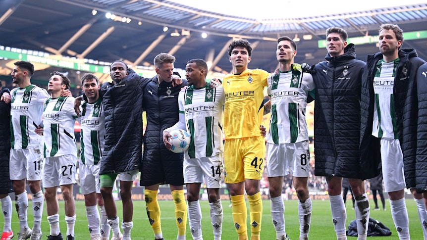 Spieler von Borussia Mönchengladbach feiern den Sieg gegen Werder Bremen mit den Fans.