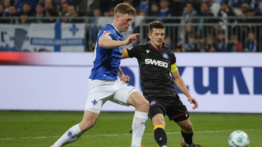 Darmstadts Clemens Riedel (links) und Karlsruhers Marvin Wanitzek (rechts) im Zweikampf.