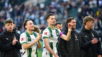 Spieler von Borussia Mönchengladbach feiern mit den Fans.